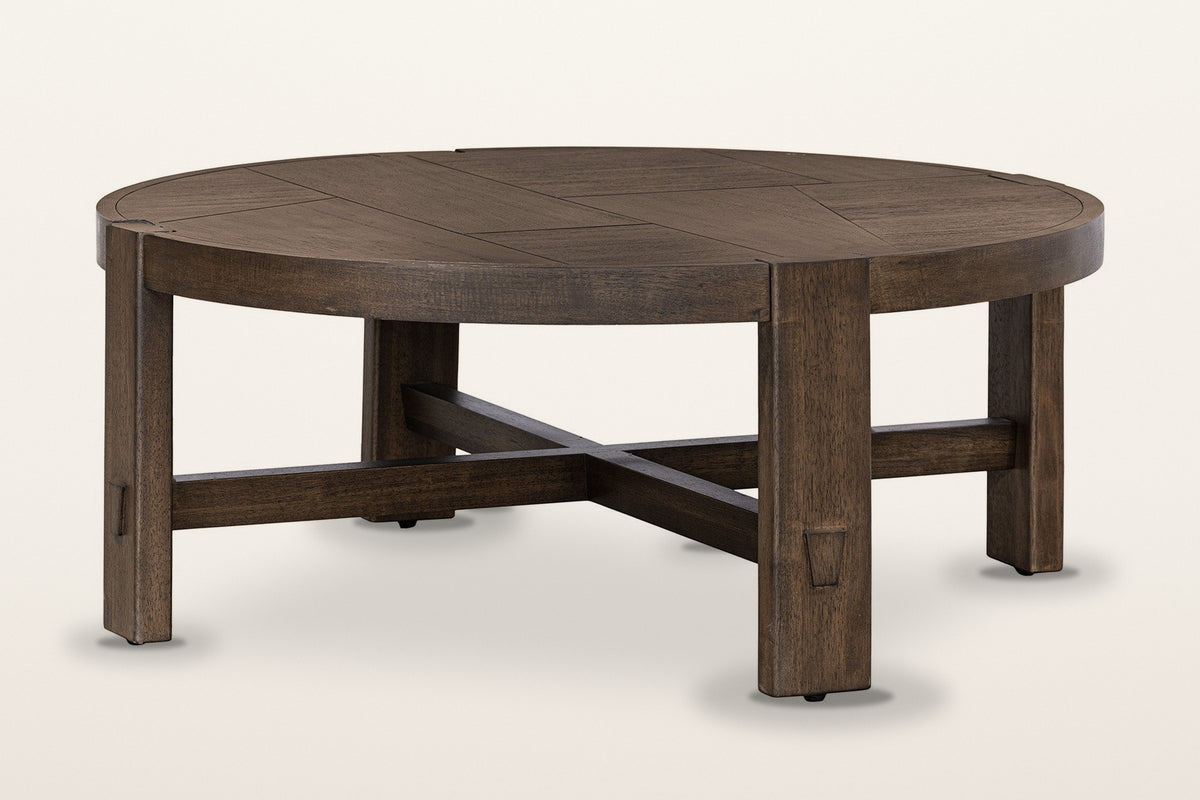 Mondavio round coffee table in Smoked Acacia, three-quarter view on a warm white studio backdrop