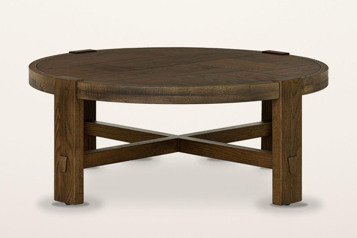 Mondavio round coffee table in Smokey Chestnut on a warm white studio backdrop: a patchwork top