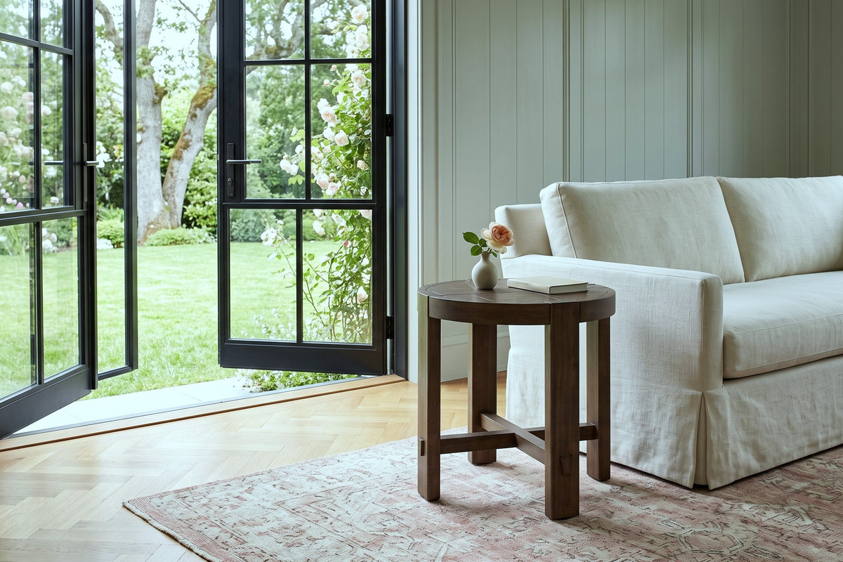 Mondavio side table in Smoked Acacia beside a skirted linen sofa in an Oak Bay house, with sage panelling