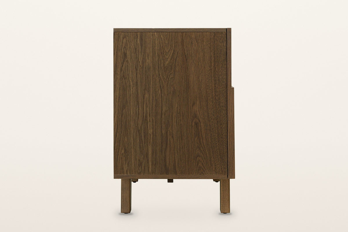 Mondavio sideboard in Smokey Chestnut, end view on a warm white studio backdrop: a plain oak end panel above a front post