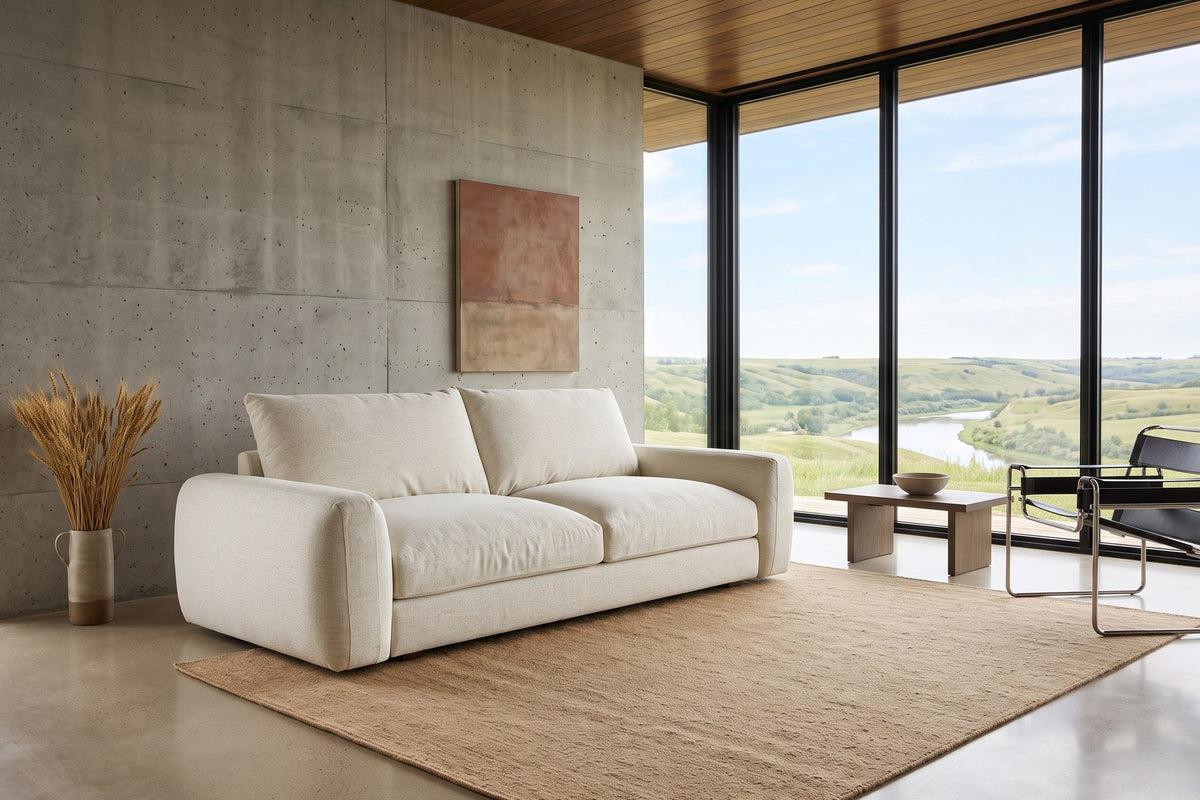 Montecassiano sofa in Cream in a Lumsden house in the Qu'Appelle Valley, with a board-formed concrete wall, a walnut ceiling