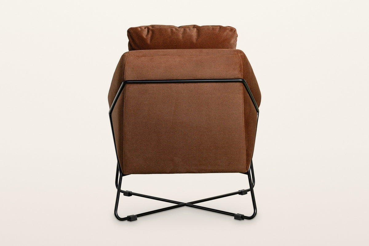 Back of the Montelupone accent chair in Rust on a warm white studio backdrop: the black rod frames the outside back