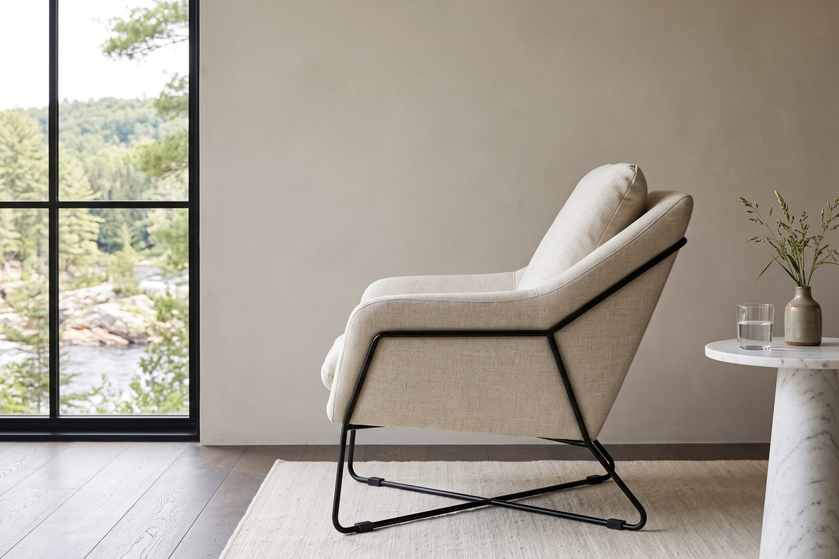 Montelupone accent chair in Taupe in side profile in a Burnstown house on the Madawaska River, greige plaster