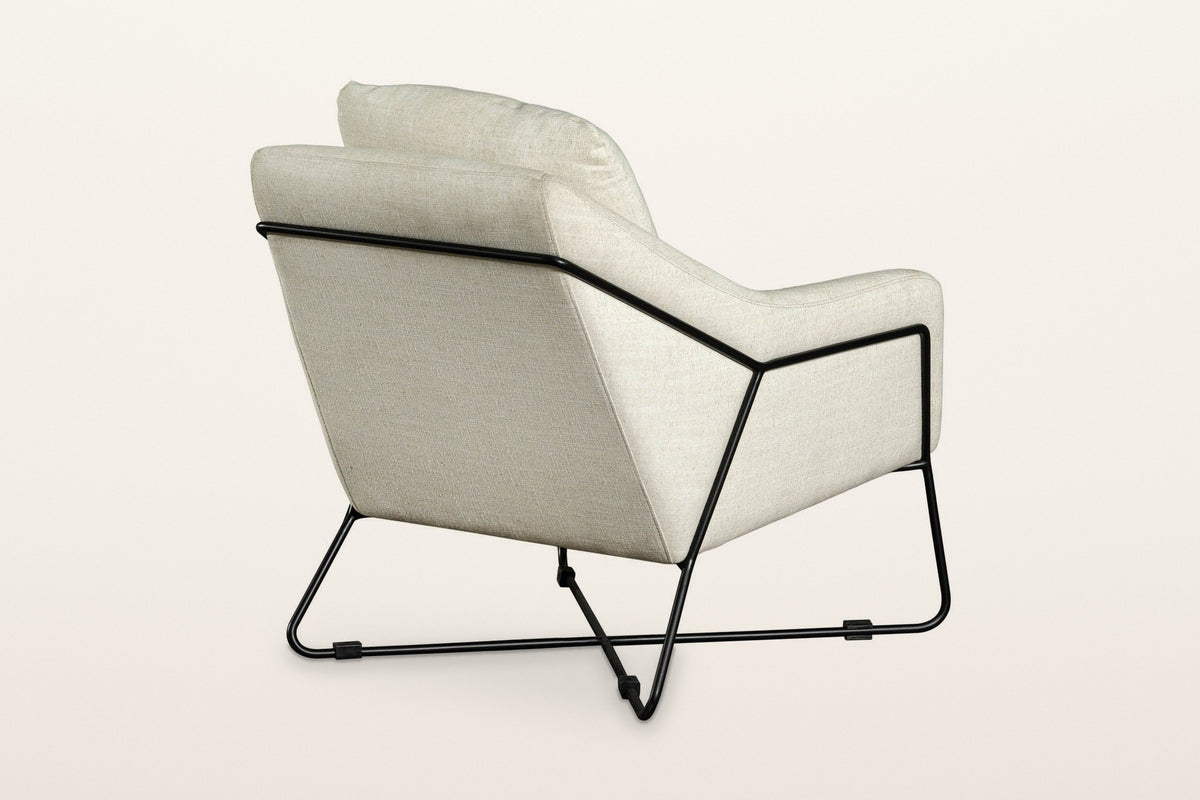 Montelupone accent chair in Taupe from the back at three-quarter on a warm white studio backdrop: the rod crosses the outside