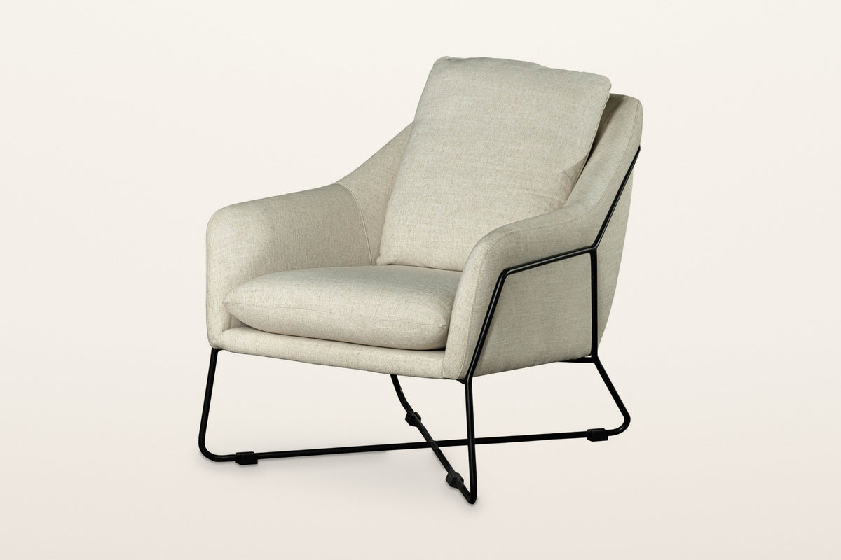 Montelupone accent chair in Taupe, three-quarter view on a warm white studio backdrop: an upholstered shell with low sloping
