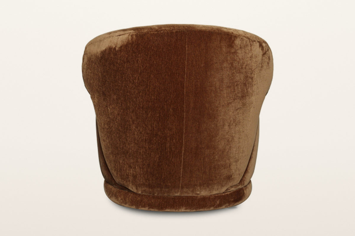 Back of the Monterubbiano accent chair in Bronze velvet on a warm white studio backdrop: one smooth curved shell with a centr