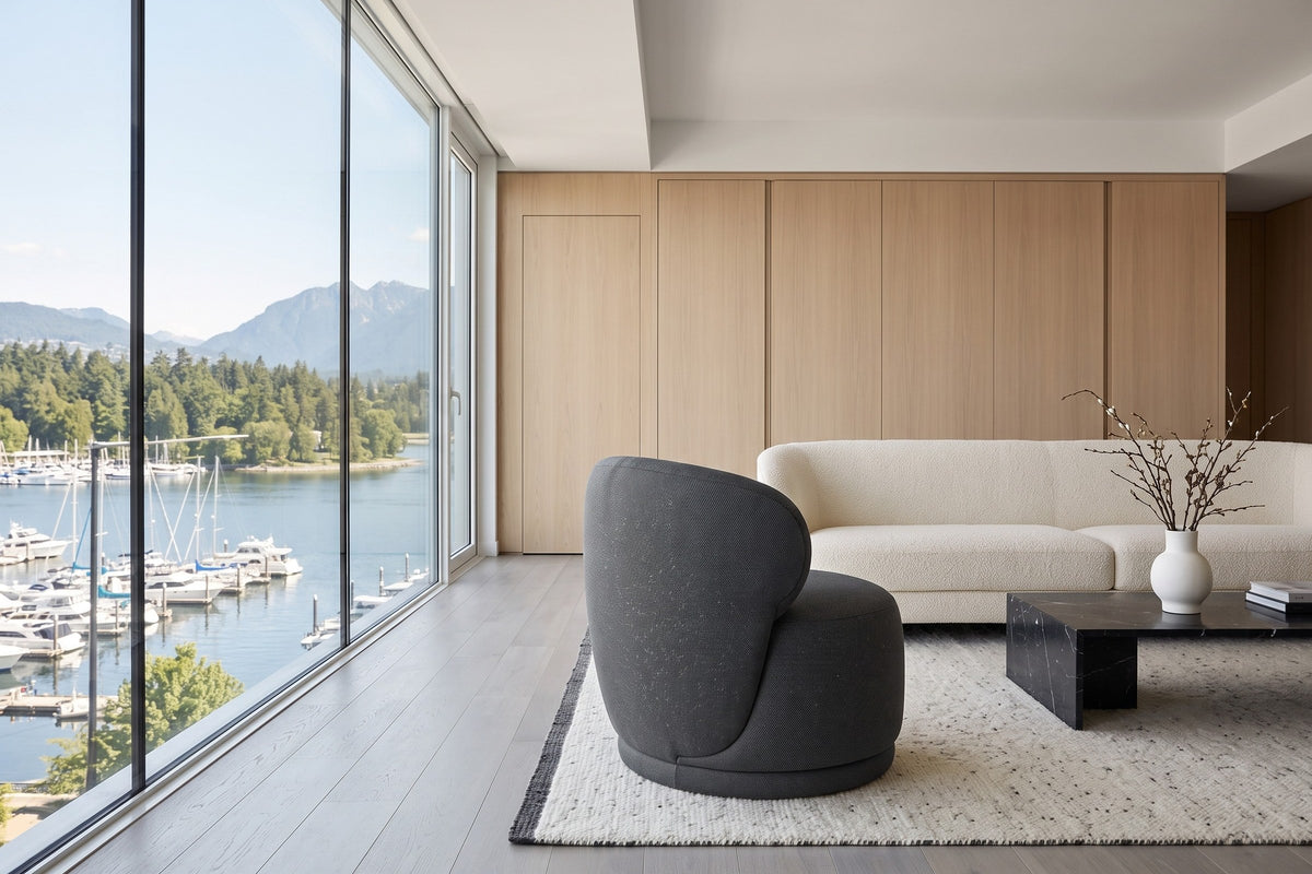 Monterubbiano accent chair in Charcoal twill seen from the side in a Coal Harbour penthouse in Vancouver