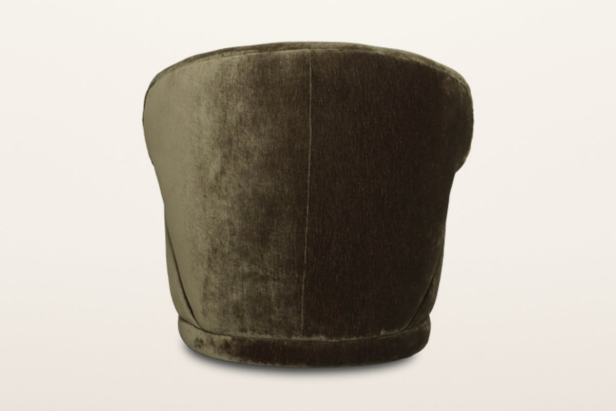 Back of the Monterubbiano accent chair in Khaki Green velvet on a warm white studio backdrop: one smooth curved shell