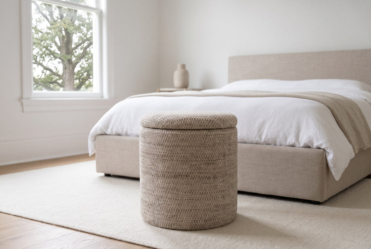 Morgex pouf in Beige at the foot of a sand linen bed in a Victoria, British Columbia bedroom, a Garry oak through the window