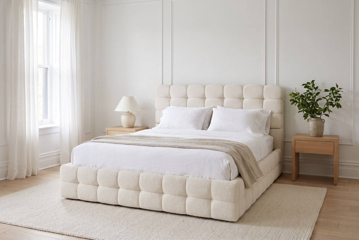 Nemi bed made up with white linen in a bright Montreal bedroom with wall mouldings, sheer curtains and light oak nightstands