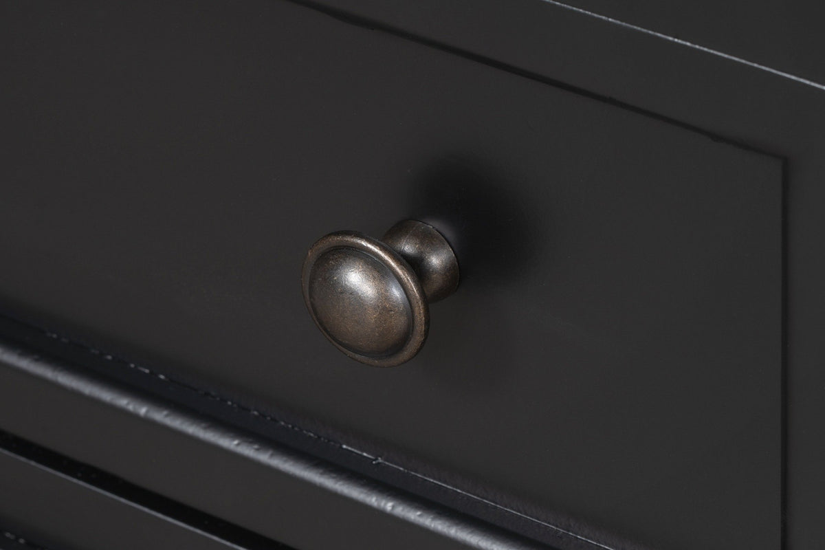 Close-up of a Nervi drawer front in Black: the moulded frame, the matte black paint and a round dark-bronze knob