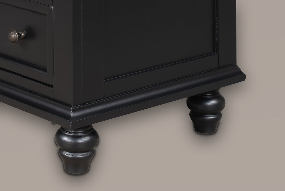 Close-up of the Nervi base in Black: the moulded plinth, the framed side panel and a turned bun foot