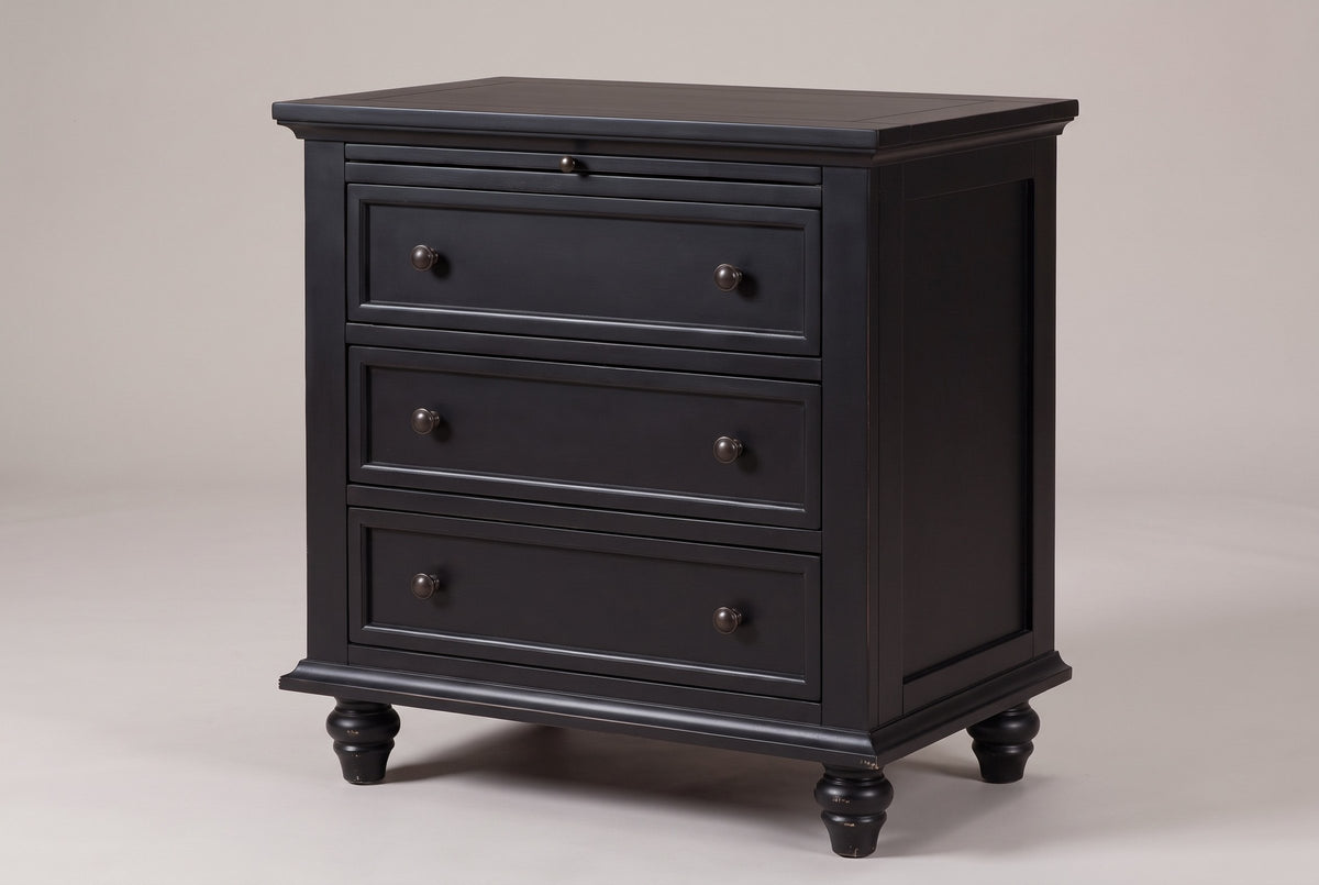 Nervi 3-drawer nightstand in Black, three-quarter view on a warm grey studio backdrop