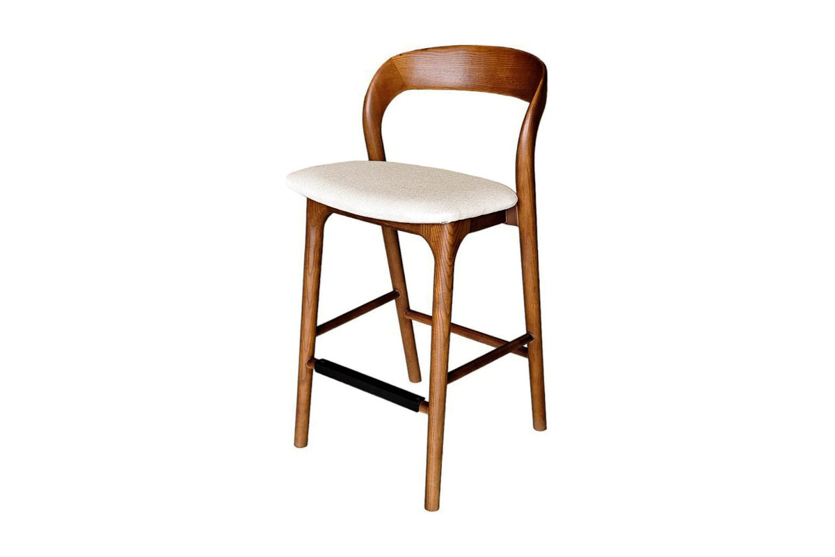 Norwood solid ash counter stool in walnut with cream fabric seat, three-quarter view