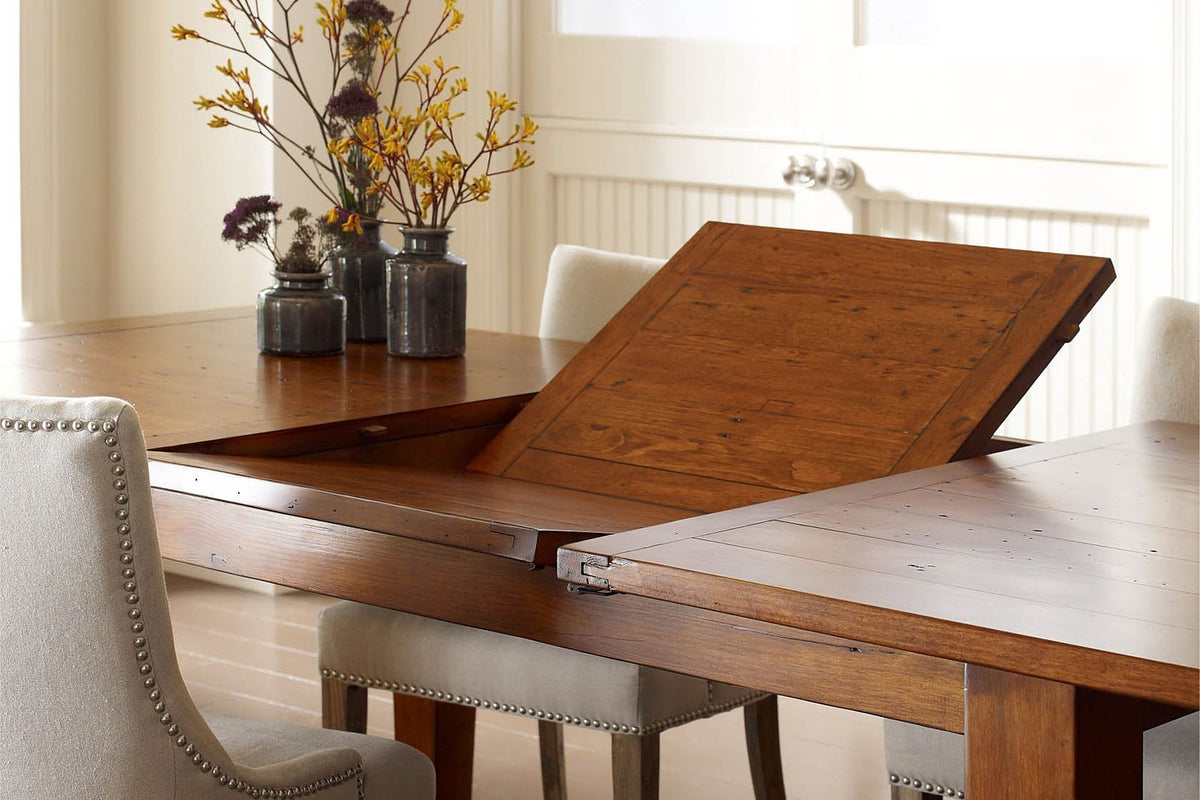 Butterfly leaf rising from the centre of the Novella dining table in a bright dining room