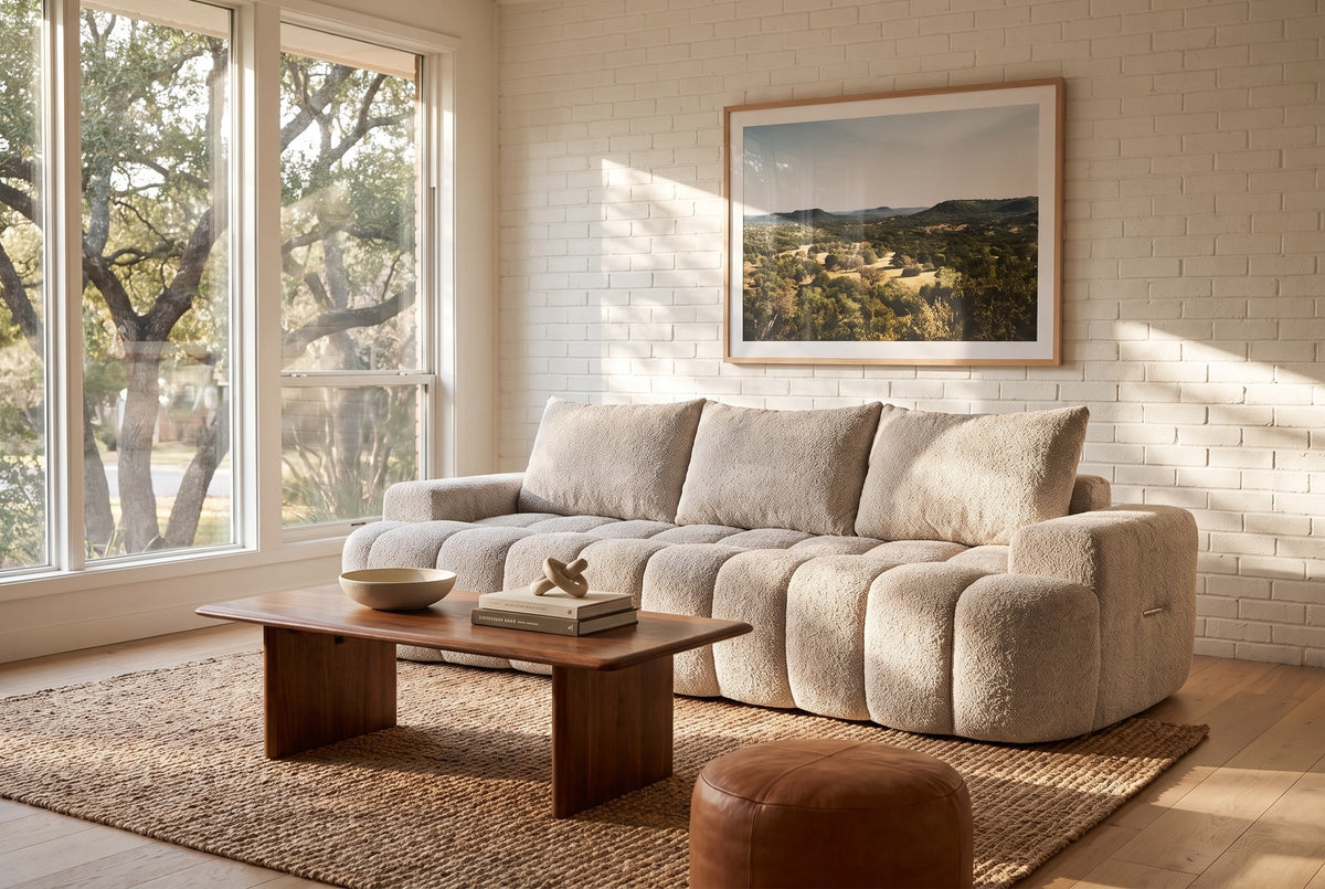The Nuvola sofa in Camel in a 1950s Austin ranch house with white brick, white oak floors and a walnut coffee table