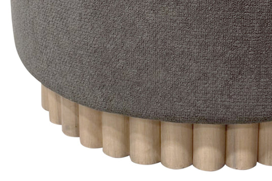 Nyla Fabric Round Storage Ottoman with Reeded Wood Base - A Reeded Wood Detail