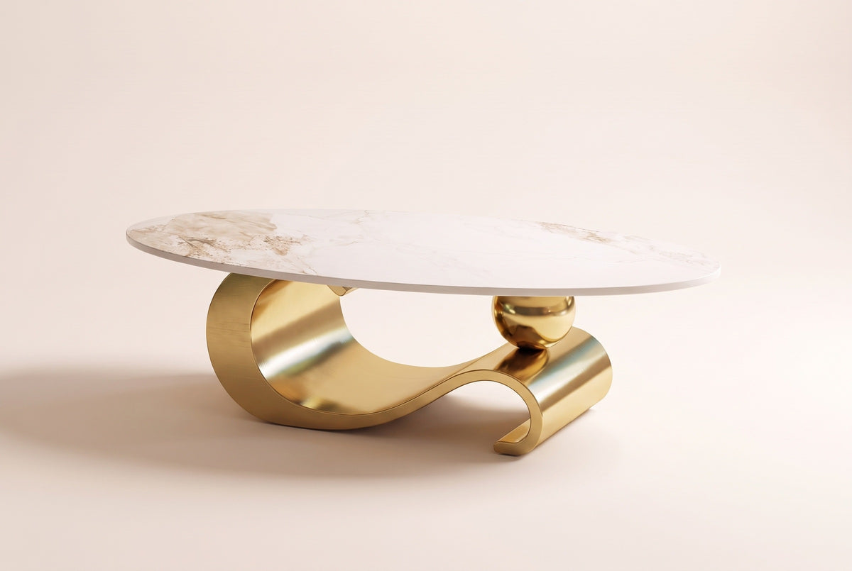 The Ondina coffee table in Gold from a little further back, showing the oval top above the curl, the wave and the sphere