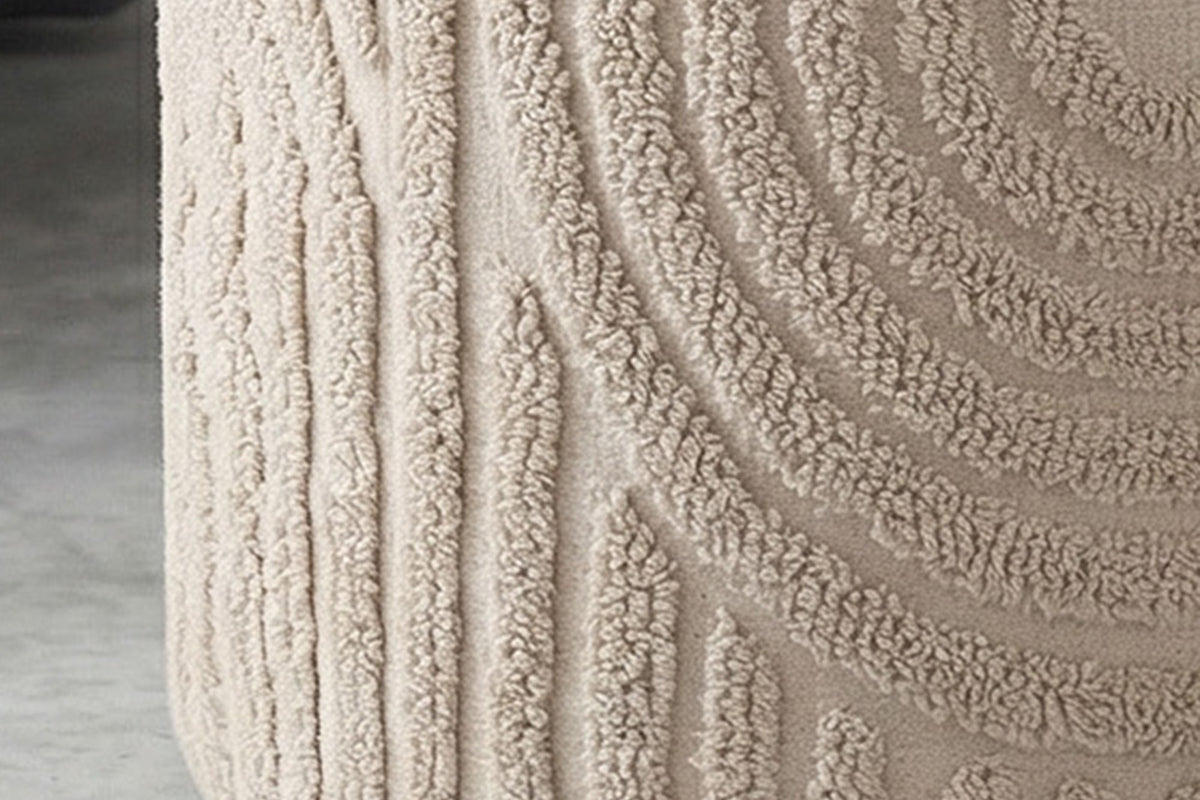 Close-up of the raised arches on the side of the beige Orla ottoman