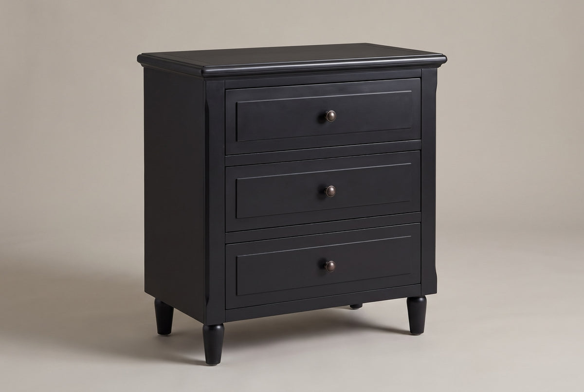 Ortona 3-drawer nightstand in Black, three-quarter view on a warm grey studio backdrop