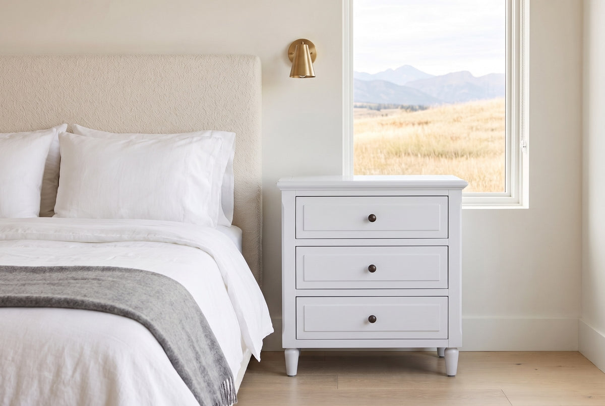Ortona nightstand in White beside a boucle bed in a Calgary bedroom with foothills in the window