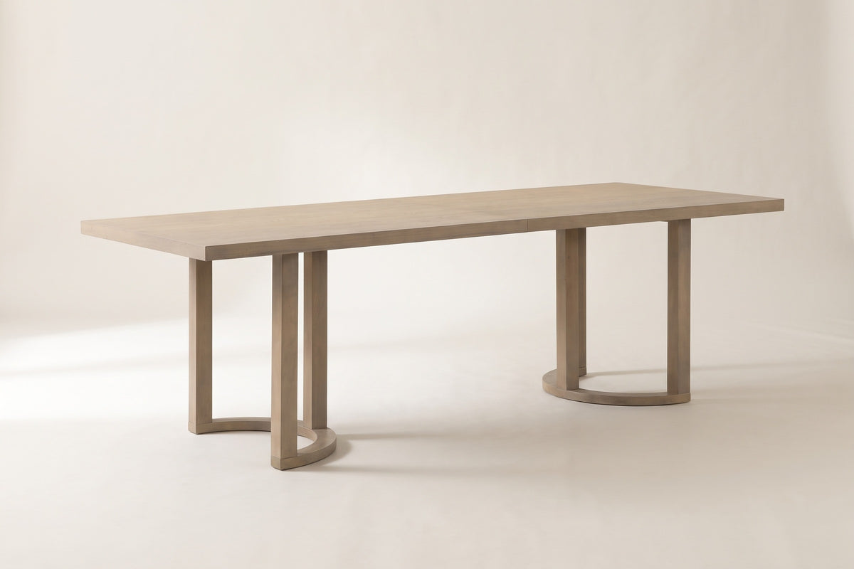 Orvieto dining table in a light ash finish on a pale studio backdrop