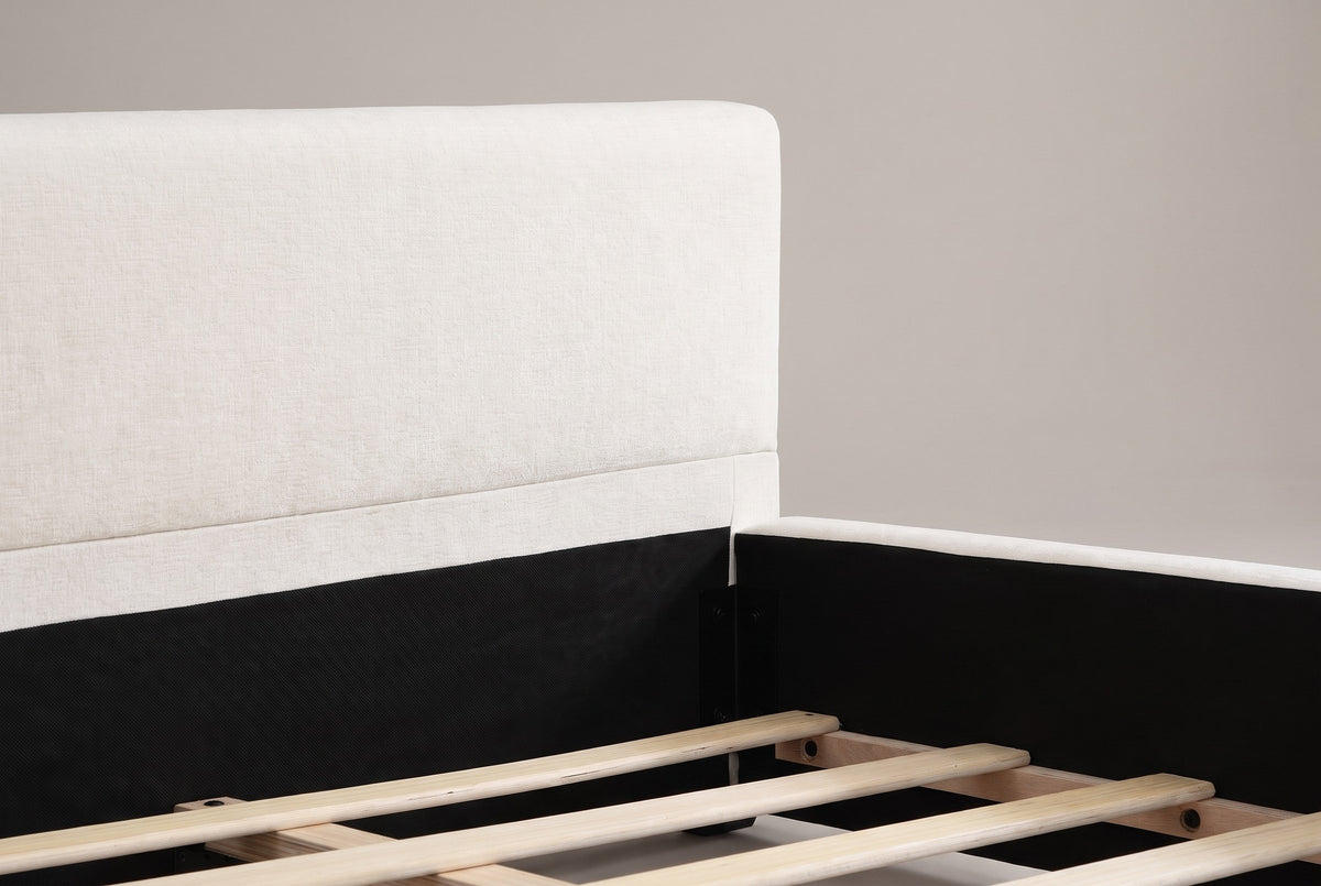 Close-up of the Otranto headboard end: the padded chenille panel over a flat lower band