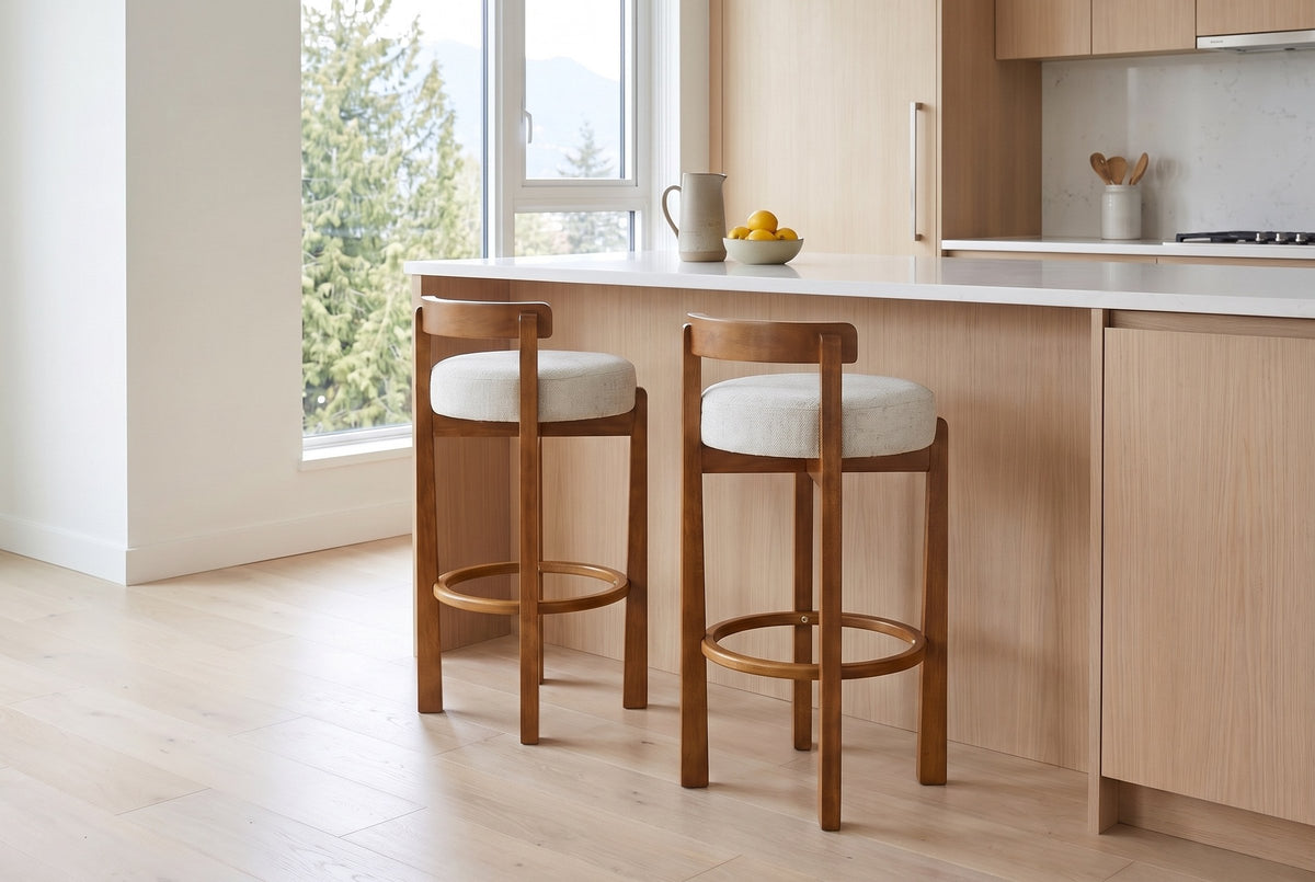 Two Otricoli bar stools in Ivory at a white-oak kitchen island in a bright Vancouver condo with a window onto cedars and moun
