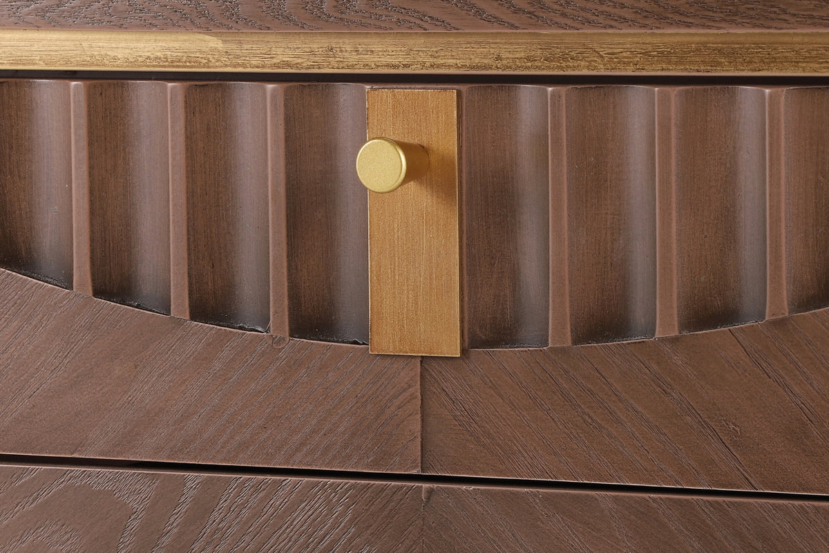 Close-up of the Pavia top drawer: carved flutes cut along an arc, the gold-tone plate and knob