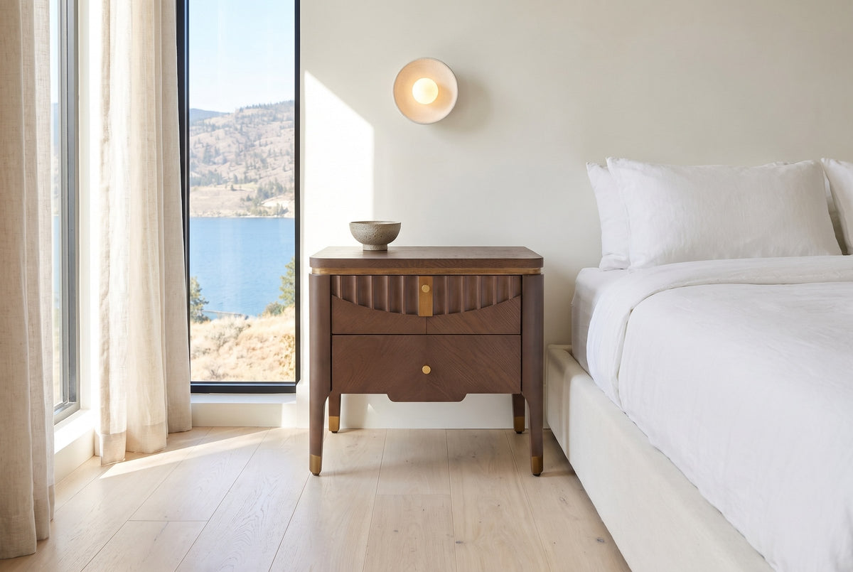 Pavia nightstand in Brown beside a low bed with white linen in a bright Kelowna bedroom with a lake view