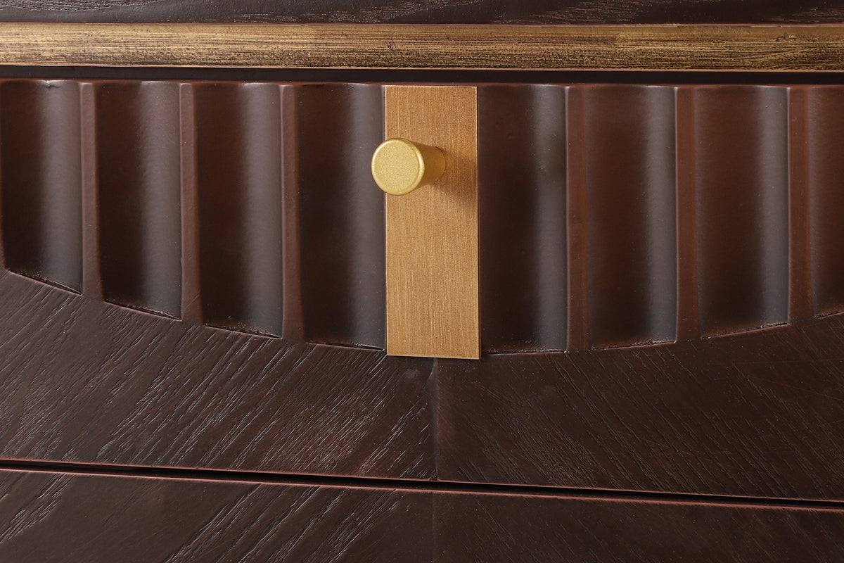 Close-up of the Pavia top drawer in Dark Brown: carved flutes cut along an arc, the gold-tone plate and knob