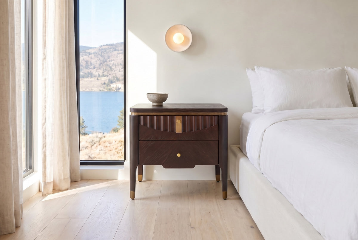 Pavia nightstand in Dark Brown beside a low bed with white linen in a bright Kelowna bedroom with a lake view