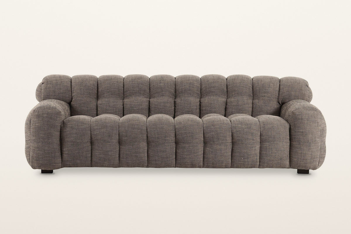 Pergola sofa in Brown, straight front view on a warm white studio backdrop: rounded puffs across the back