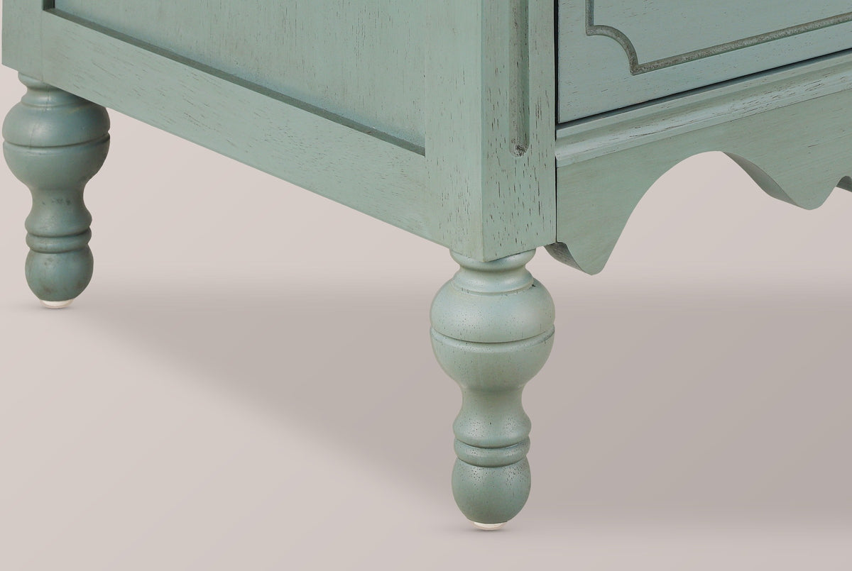 Close-up of a turned gourd leg, the grooved corner post and the scalloped apron of the Perugia nightstand in Aged Blue