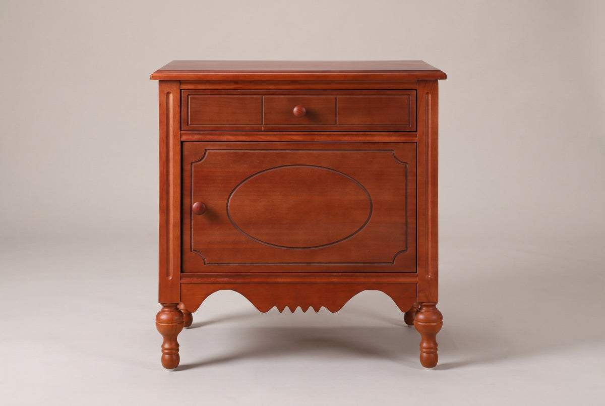 Perugia nightstand in Russet Brown, straight front view: one drawer over one door with a routed oval, four turned legs