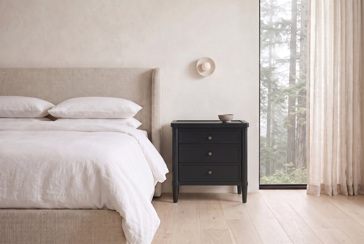 Pescara nightstand in Black beside a bed with white linen in a plaster Vancouver bedroom with a misty cedar view