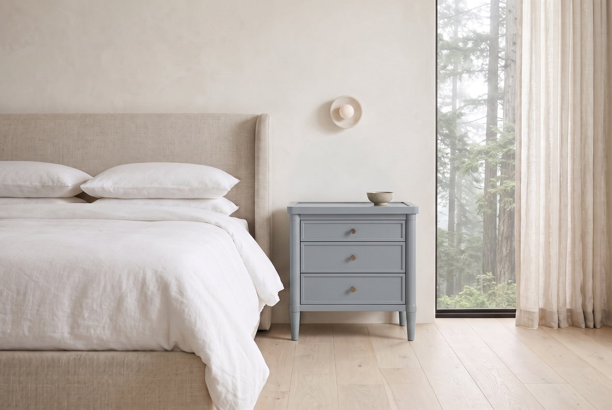 Pescara nightstand in Slate Gray beside a bed with white linen in a plaster Vancouver bedroom with a misty cedar view