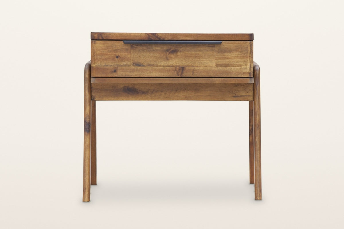 Pescasseroli end table in Brown, front view on a warm white studio backdrop: the drawer front of short acacia pieces with one black bar pull on its top edge
