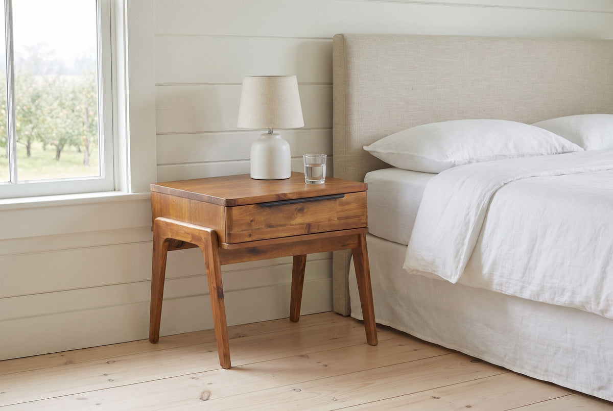 Pescasseroli end table in Brown acacia used as a nightstand beside an oatmeal linen bed in a Wolfville farmhouse bedroom