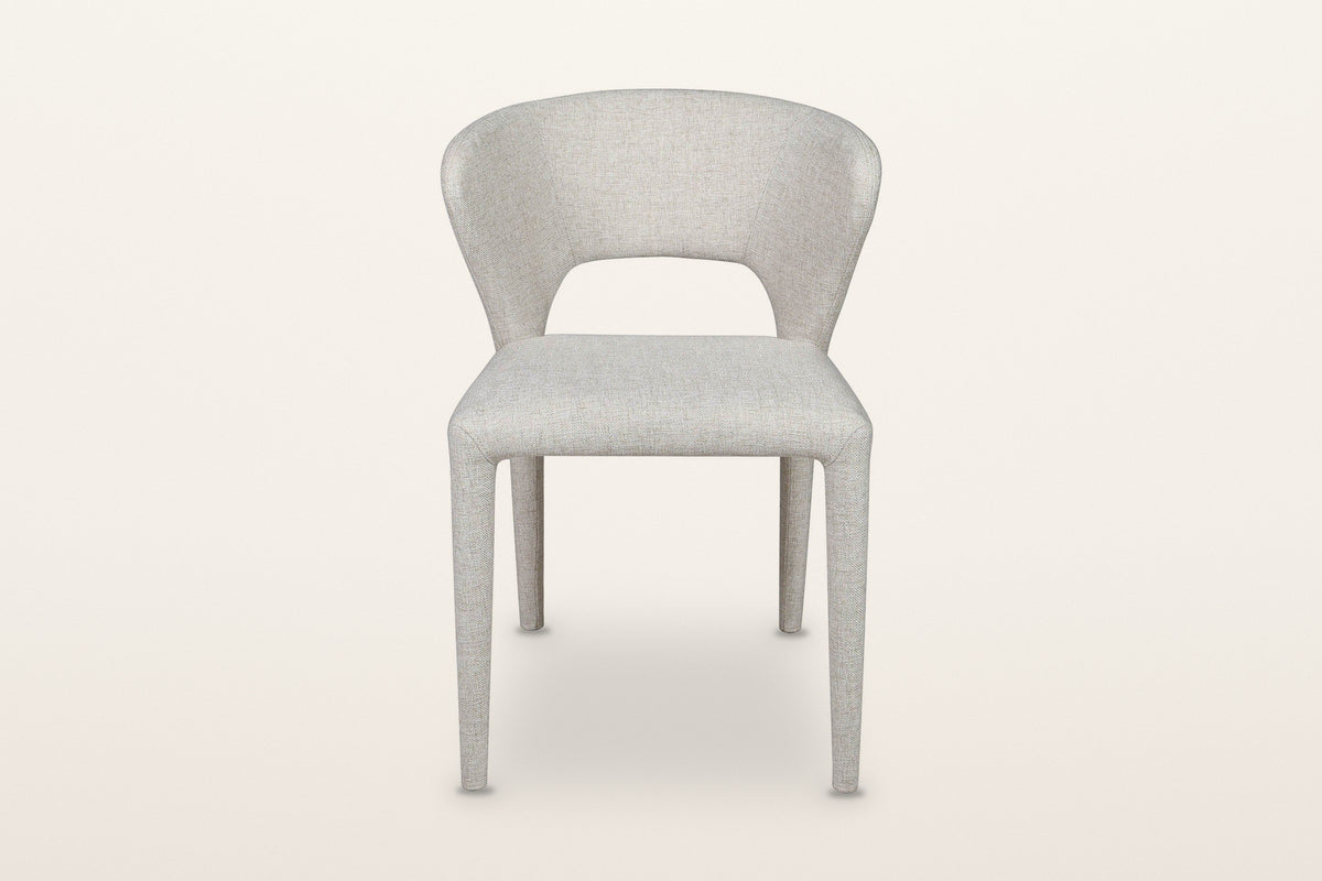 Petralia dining chair in Beige tweed, straight front view on a warm white studio backdrop: the open window between the seat