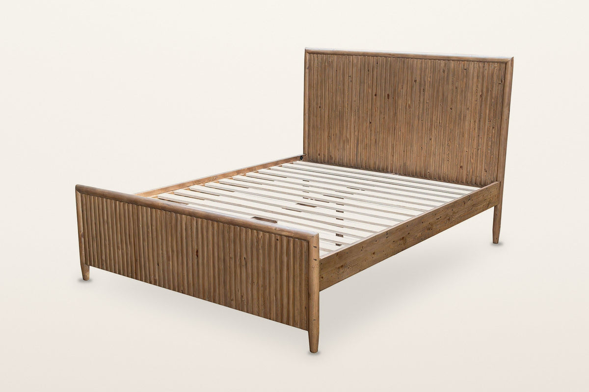 Pettorano bed frame without a mattress, three-quarter view on a warm white studio backdrop: the pale slats inside the reclaim