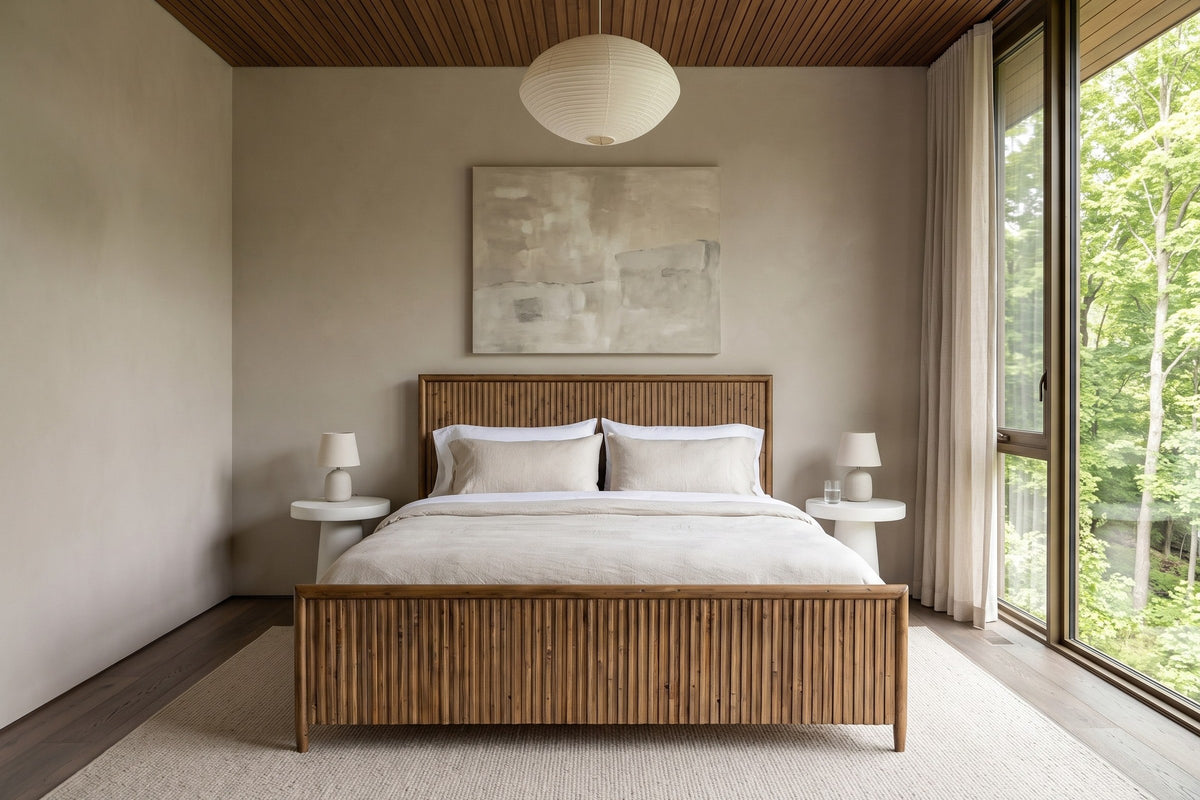 Front view of the Pettorano bed in a bedroom in a Terra Cotta forest house in the Credit River valley, with greige plaster