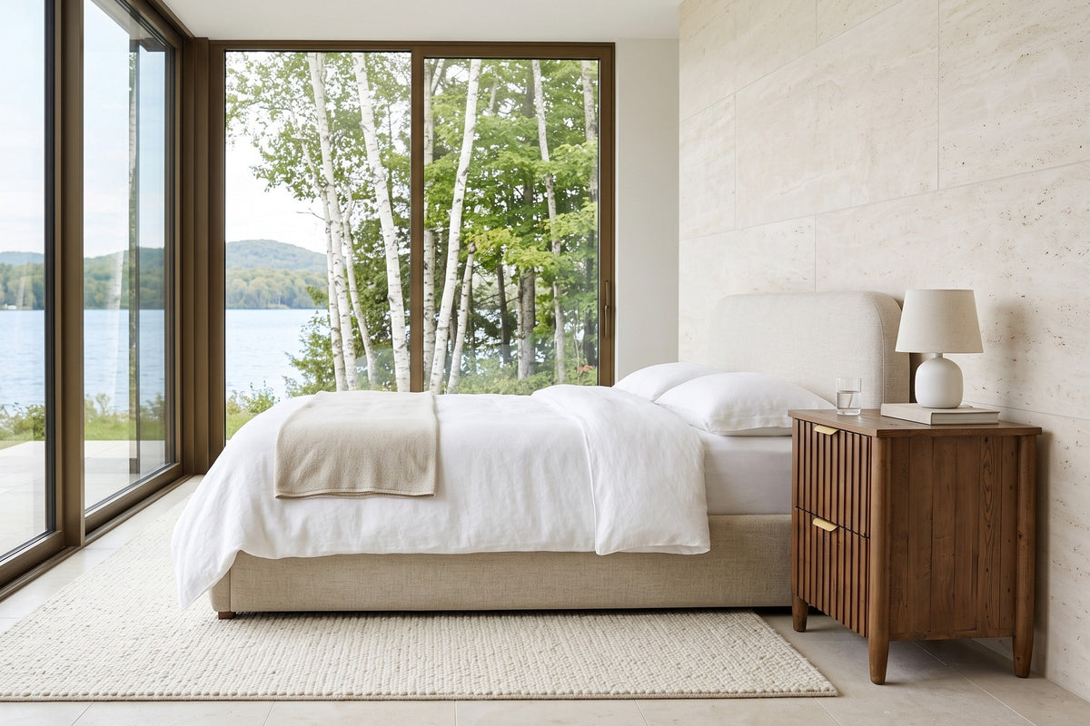 Pettorano nightstand in Brown reclaimed pine beside an oatmeal upholstered bed in a Sainte-Agathe lake house bedroom