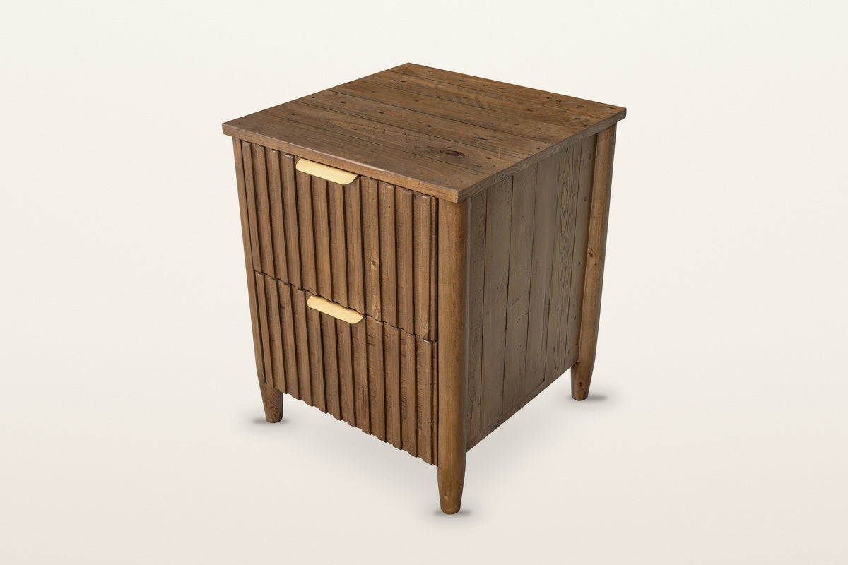 Pettorano nightstand in Brown reclaimed pine, three-quarter view on a warm white studio backdrop: two reeded drawers with bra