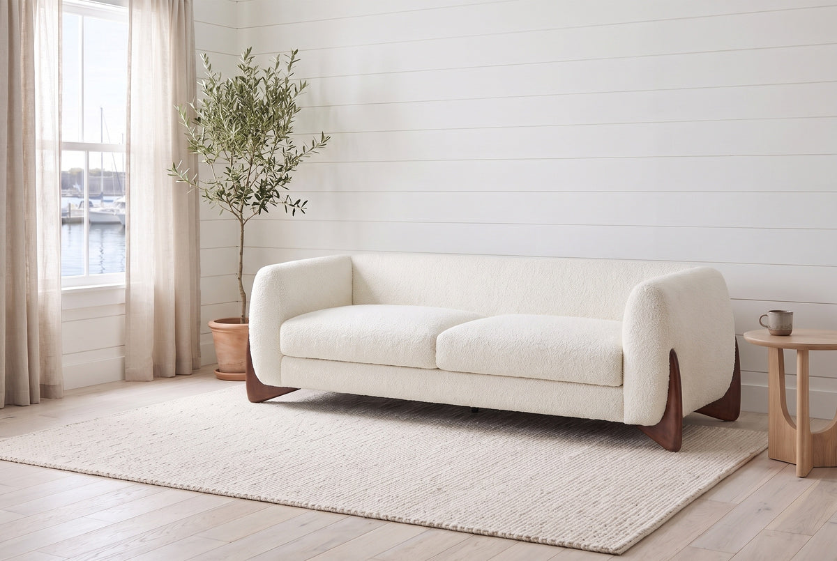 Pistoia sofa in Beige boucle in a bright Halifax room with shiplap walls, an olive tree and the harbour through the window