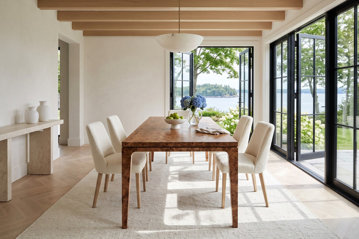 End view of the Polcenigo dining table in Dark Burl in a Chester house on Mahone Bay, with limewashed walls, oak beams