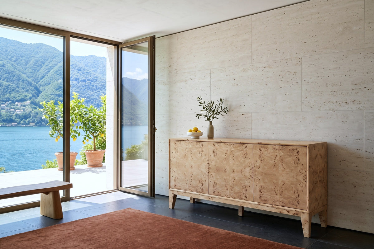 Polcenigo sideboard in Honey Blonde Burl against a travertine wall in a villa in Morcote, with basalt tiles, a rust rug