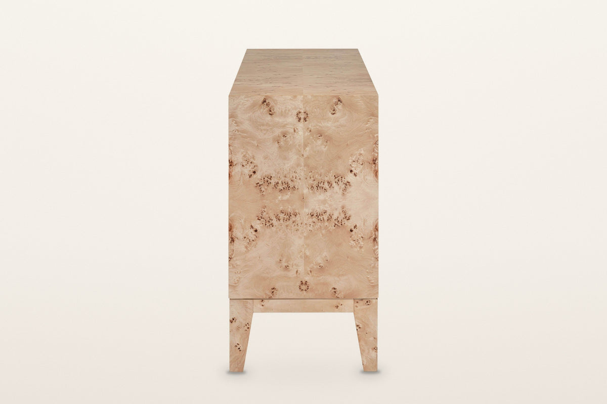 Polcenigo sideboard in Honey Blonde Burl, end view on a warm white studio backdrop: a book-matched burl end panel over the ra