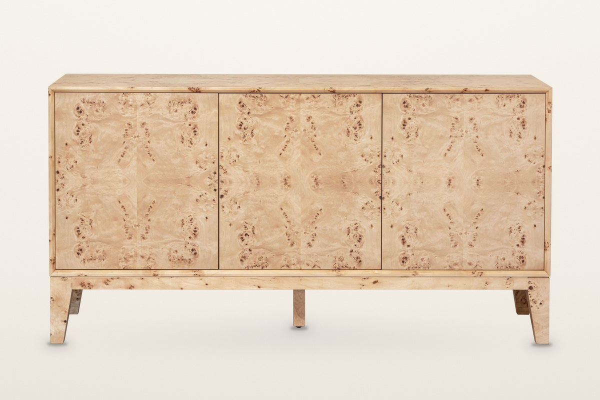 Polcenigo sideboard in Honey Blonde Burl, straight front view on a warm white studio backdrop: three equal flush doors in a s