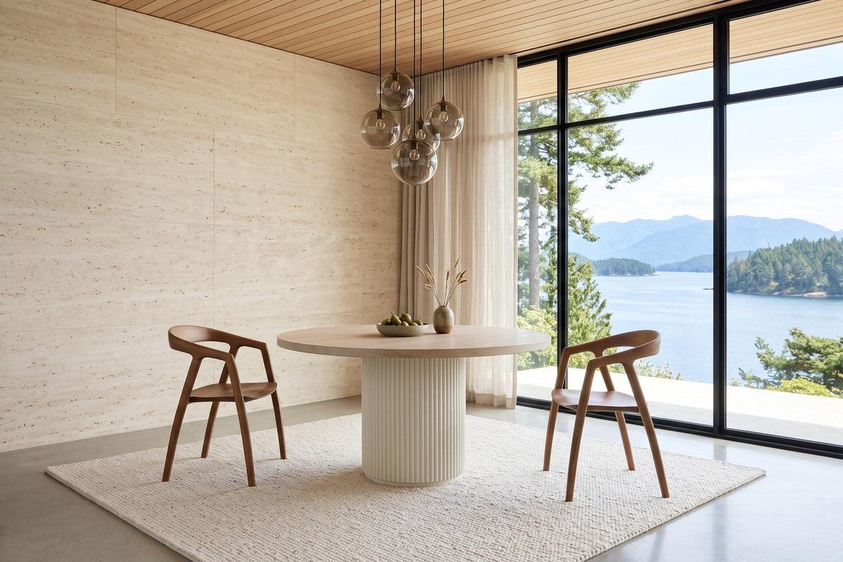 Two Pollica dining chairs in Caramel at a round fluted pedestal table in a Bamfield house on Barkley Sound